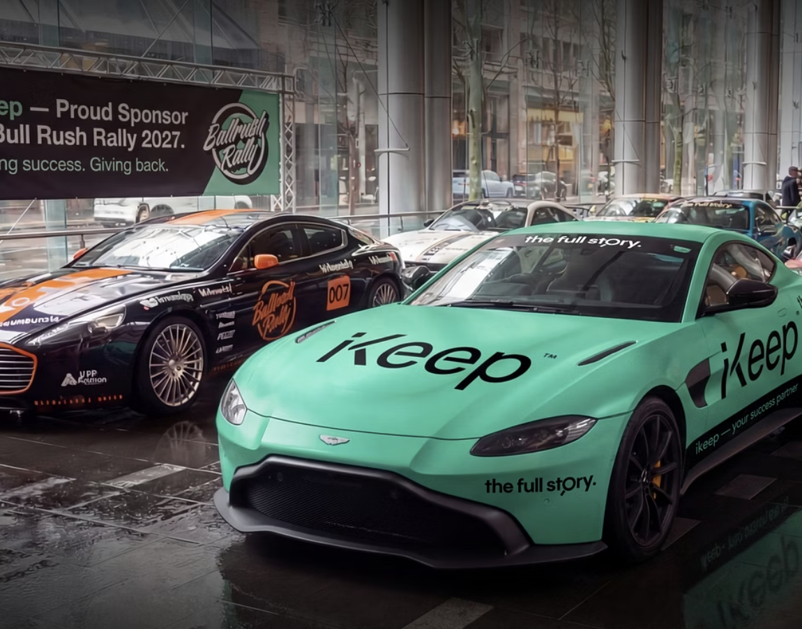 The spearmint-green iKeep Aston Martin with 'the full story.' livery on the Bullrush Rally grid, beside an iKeep proud sponsor banner.