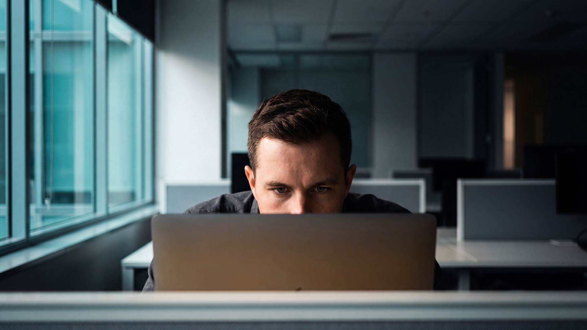 A focused business owner studying their numbers on a laptop in a quiet office