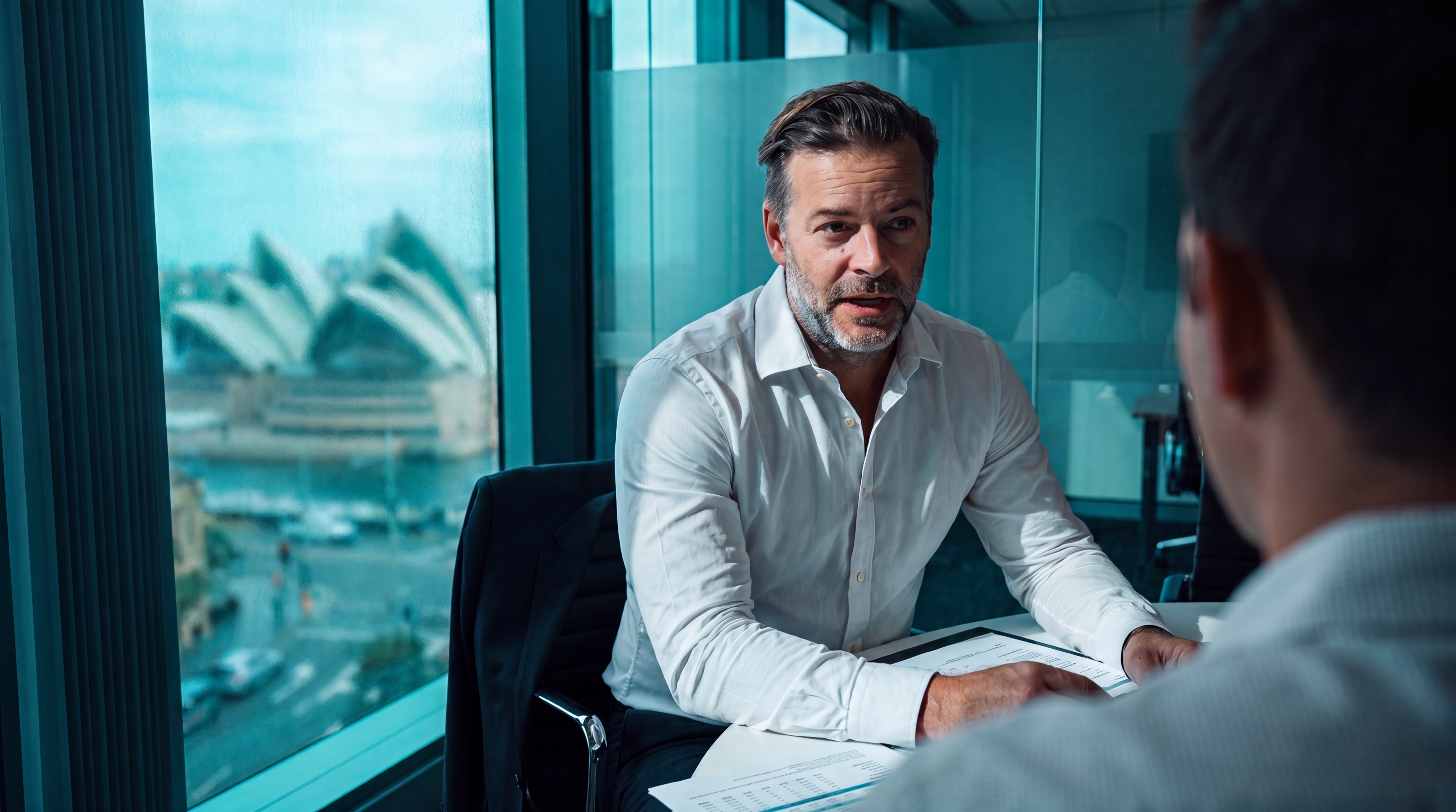 A chartered accountant leading an iKeep strategy session with a client, overlooking Sydney Harbour